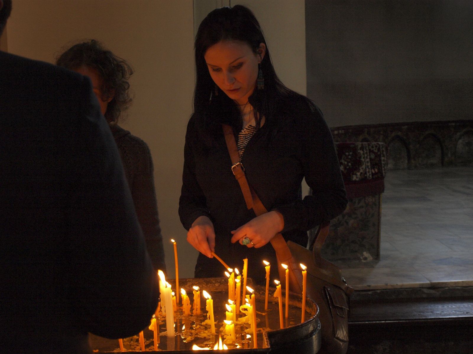 Vendula Krcmarova is lighting a candle in the cathedral.jpg