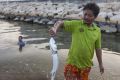 Rybář poskytující rybu nedaleko průmyslového gigantu Map Tha Put